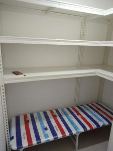 Shelving with bed under